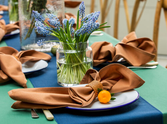 Cinnamon napkin with Oxford Blue table runner on Forest Green table cloth